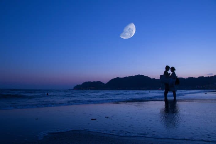 Couple holding each other on the shore