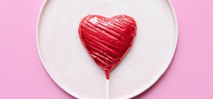 heart lollipop on white ceramic plate