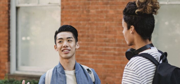 Two young guys talking to each other