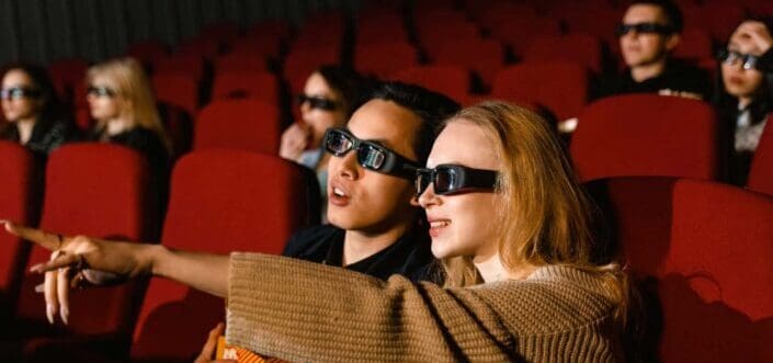 People inside a theater watching a movie.