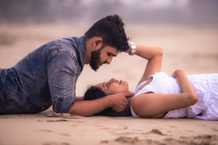 Sweet couple lying on the sand together