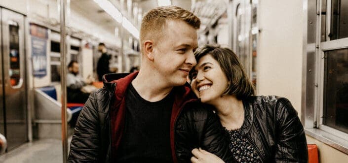 Sweet couple sitting inside a train.