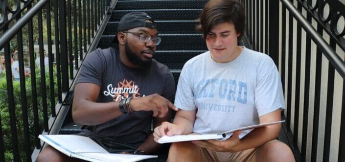 Two men checking out something on a catalogue