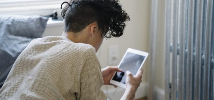 Man using tablet on bed