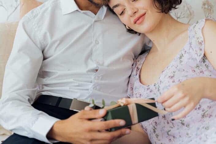 Lady opening her gift from his boyfriend