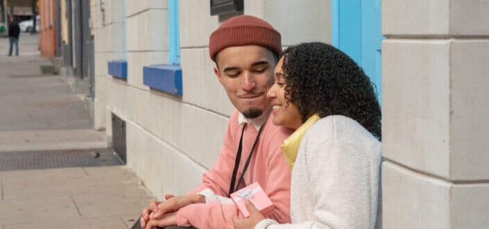Sweet couple sitting along the side walk