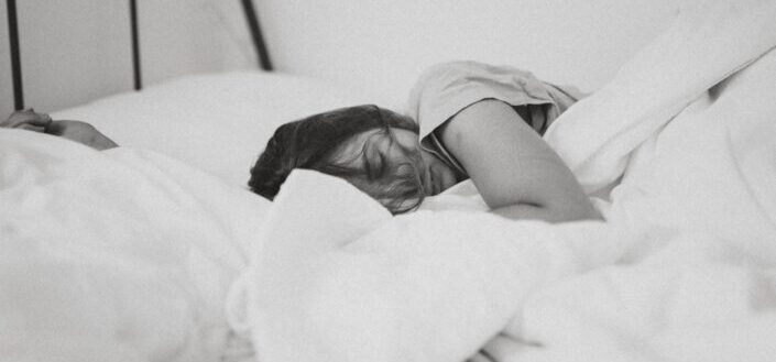 woman sleeping on her bed