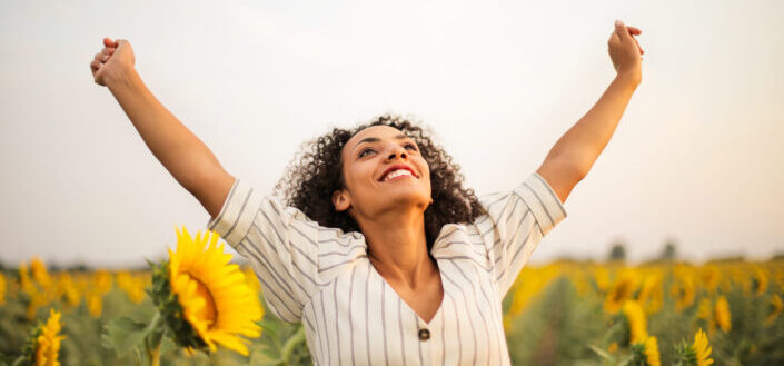 woman standing on sunflower field