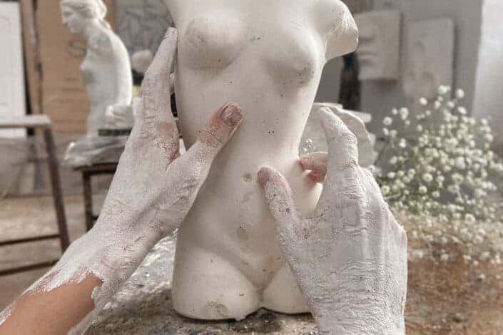 Artist creating clay sculpture
