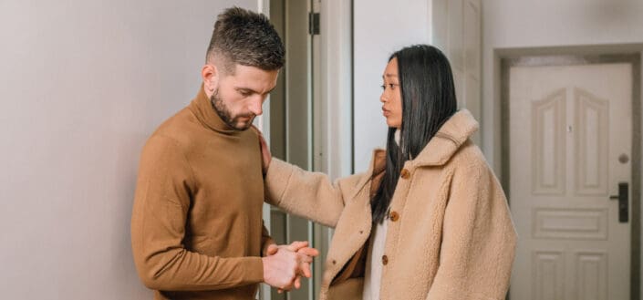 woman confronting his man near the door