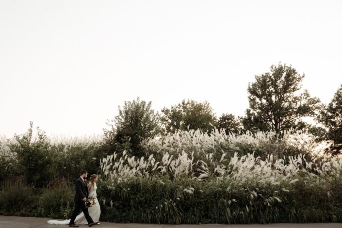 Newlyweds walking in a field