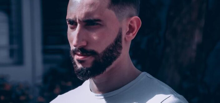 Guy with a well trimmed beard wearing a white shirt