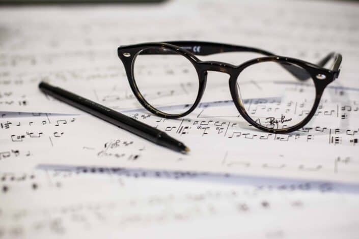 Glasses and Pen On Music Sheets