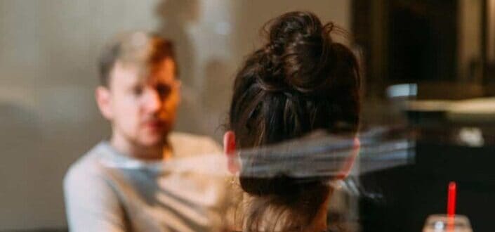 Two people talking to each other in a coffee shop