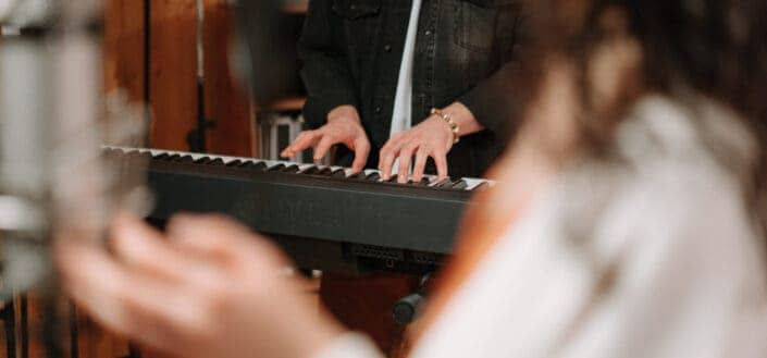 Person Playing Piano Keyboard