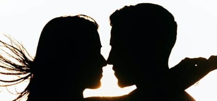 couple standing on the beach during sunset