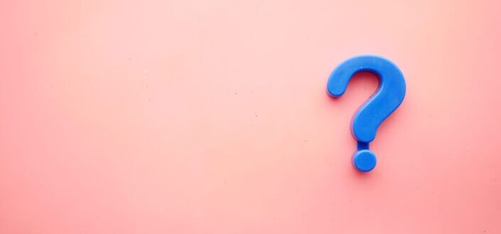 Blue question mark with a pink background