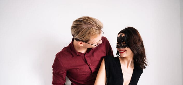 Woman Wearing a Lace Eye Mask and a Man Looking Into Each Other's Eyes