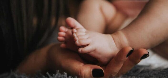 Tiny delicate feet of a newborn