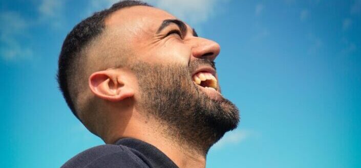 Man Laughing While Looking Up