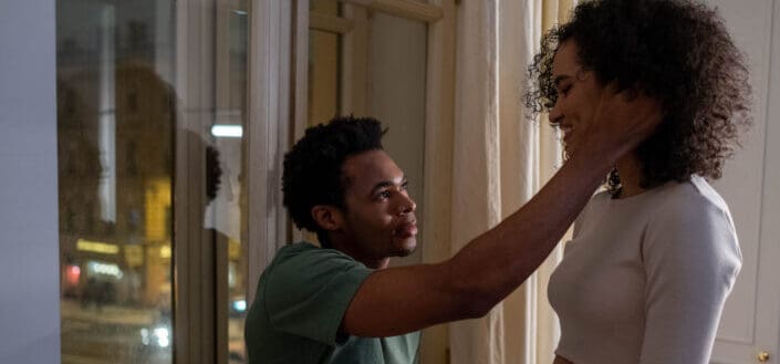 Man Tucking His Girlfriend's Hair Behind Her Ears