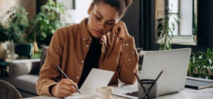 Woman Writing on Her Notebook