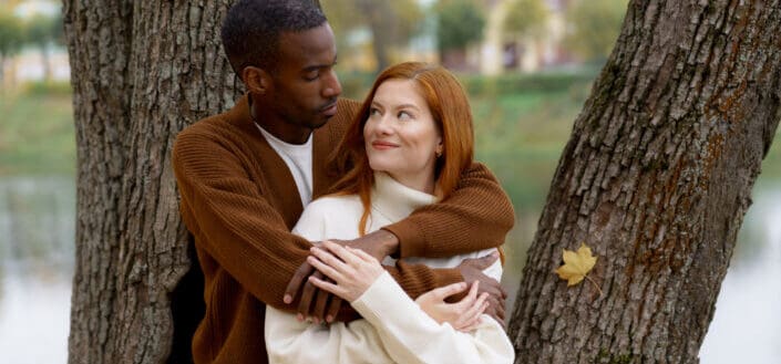 Man Hugging His Girlfriend from Behind While Looking at Each Other