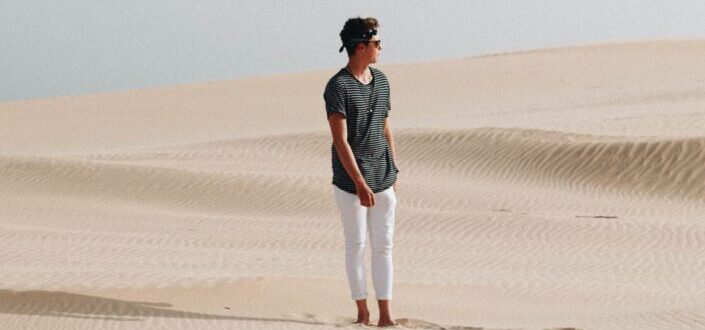 Man Walking Along the Sand Dunes