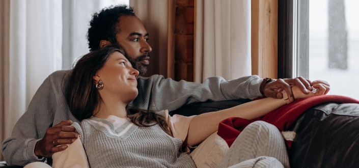 Man and woman sitting on a couch