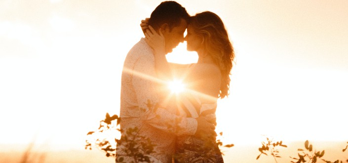 Man and woman embracing each other during a golden hour