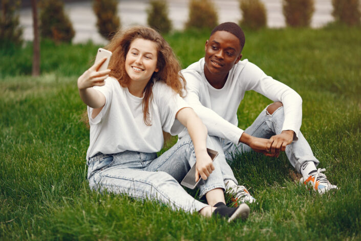 a-man-and-a-woman-sitting-on-green-grass-field-stockpack-pexels