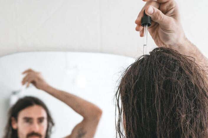 Man Applying Hair Products