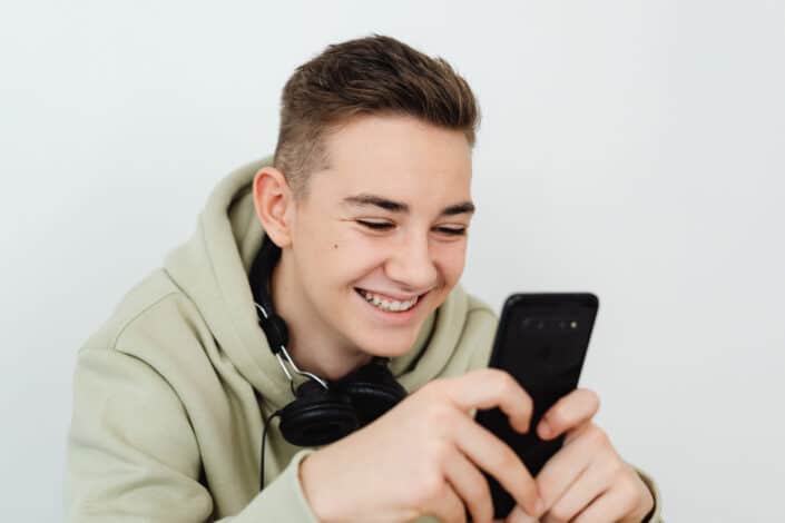 a-man-holding-a-smartphone-smiling-stockpack-pexels