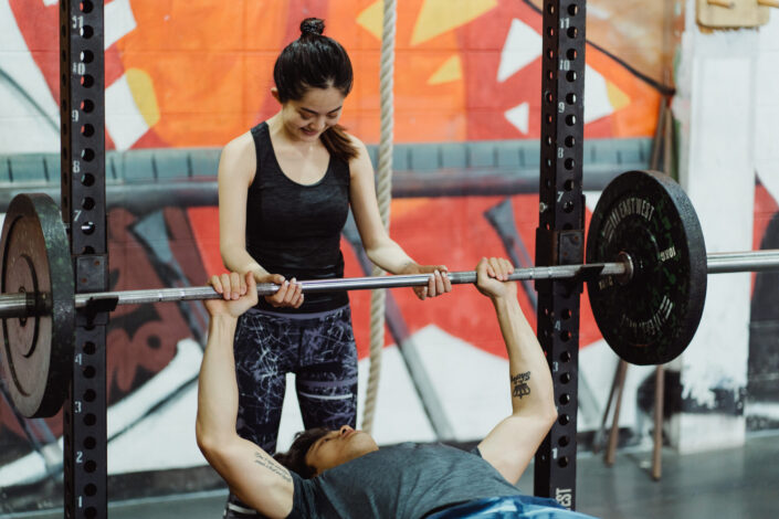 A man lifting a barbell with weight plates