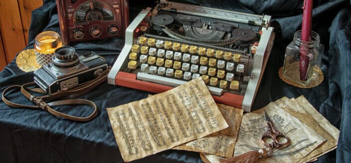 A vintage camera and typewriter on the table