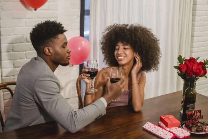 african-american-couple-drinking-wine-at-wooden-table-stockpack-pexels