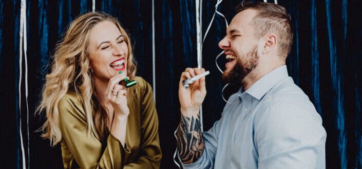couple-laughing-while-holding-party-horns-stockpack-pexels