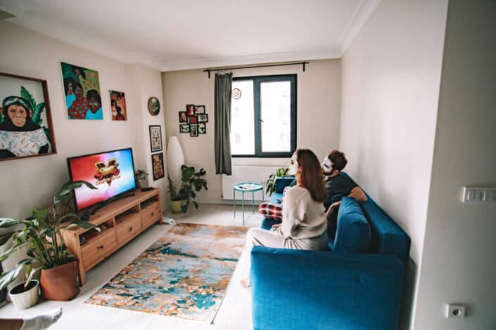 Couple sitting on a sofa watching television