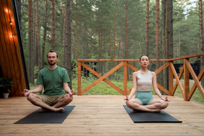 Couple sitting on yoga mats