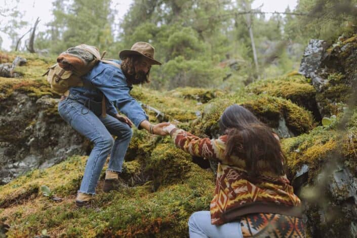 Man and woman climbing a mountainside