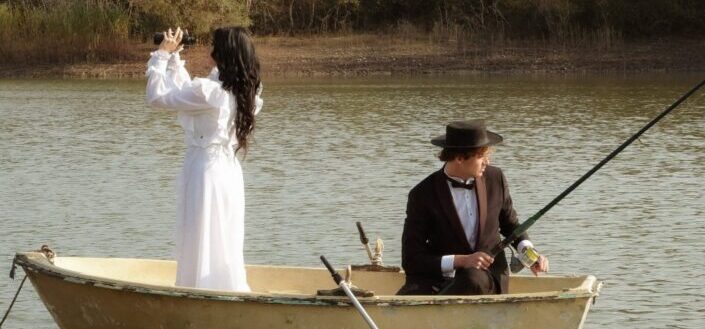 Man and woman riding on boat on lake