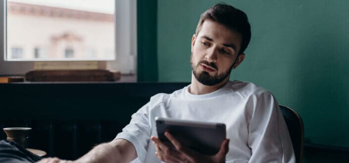 man-in-white-shirt-holding-an-ipad-stockpack-pexels