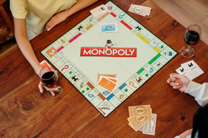 People Playing Monopoly Board Game