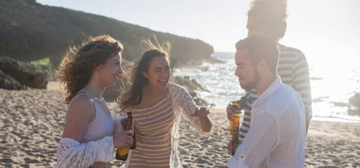 people-standing-on-beach-sand-while-drinking-beer-stockpack-pexels