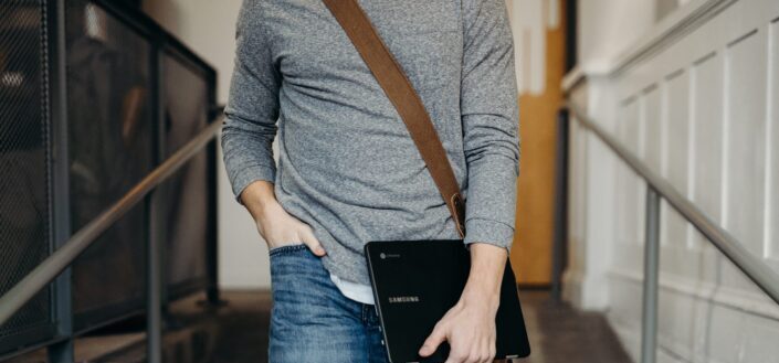 Person Carrying Black Laptop While Walking