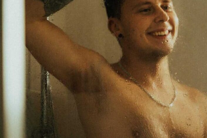 Topless Man Smiling in the Shower