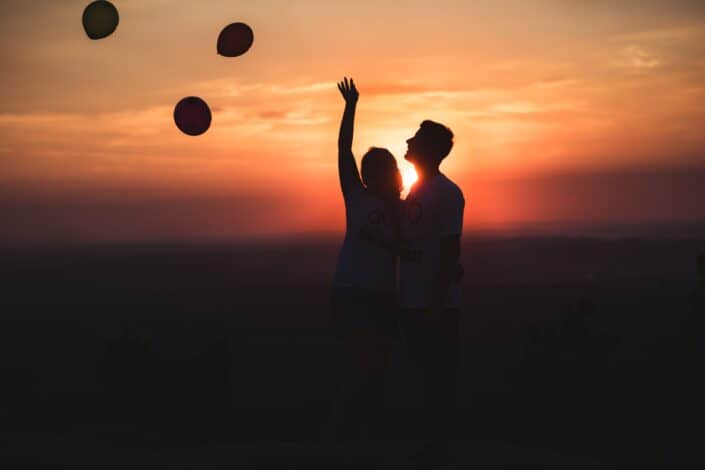 Silhouette photo of couple standing outdoors