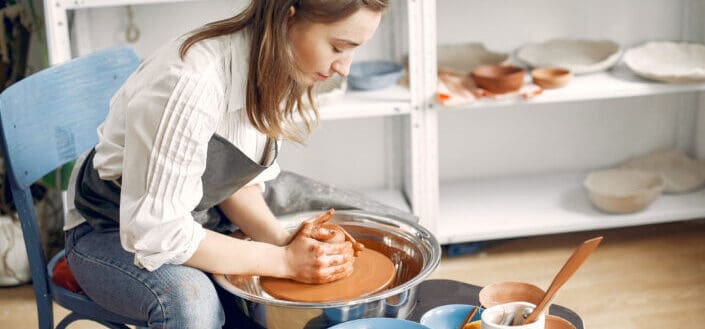 Woman Forming Clay Bowl on Pottery Wheel