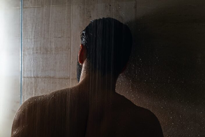 Man Leaning Against The Wall While Taking a Shower