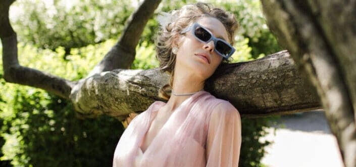 Woman in pink dress wearing sunglasses